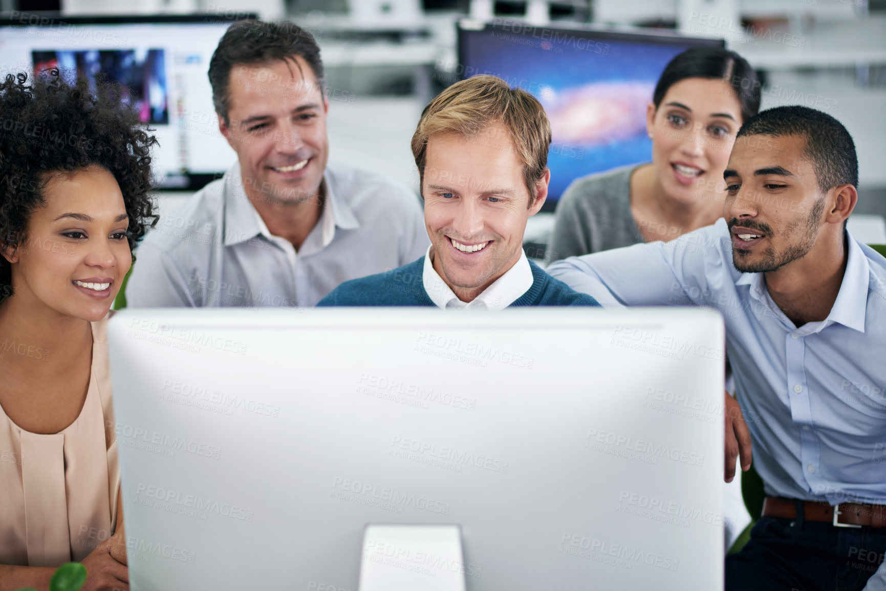 Buy stock photo Shot of a group of creative businesspeople working together on a computer in the office