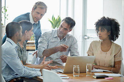 Buy stock photo Shot of a group of professionals using wireless technology during a meeting