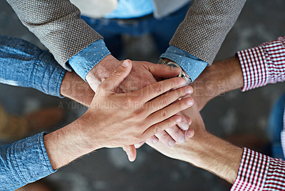 Buy stock photo Hands stacked and piled to show team unity, strength and motivation among business men, colleagues and coworkers. Above view, closeup and huddled group of businesspeople in a support and trust circle