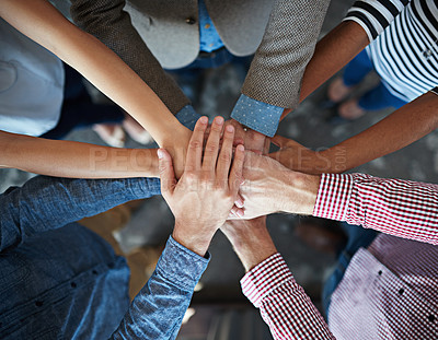 Buy stock photo Top view of co-workers hand put together in an expression of unity and team spirit