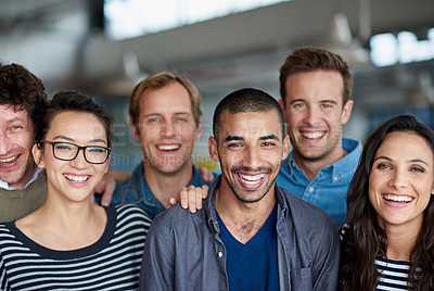 Buy stock photo Shot of a smiling group of coworkers standing in an office