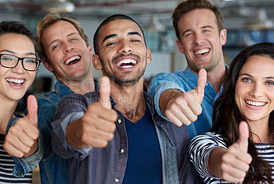 Buy stock photo Positive group of creative professionals smiling and showing thumbs-up signs