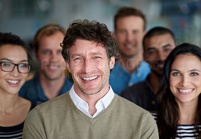 Buy stock photo Shot of a smiling group of coworkers standing in an office
