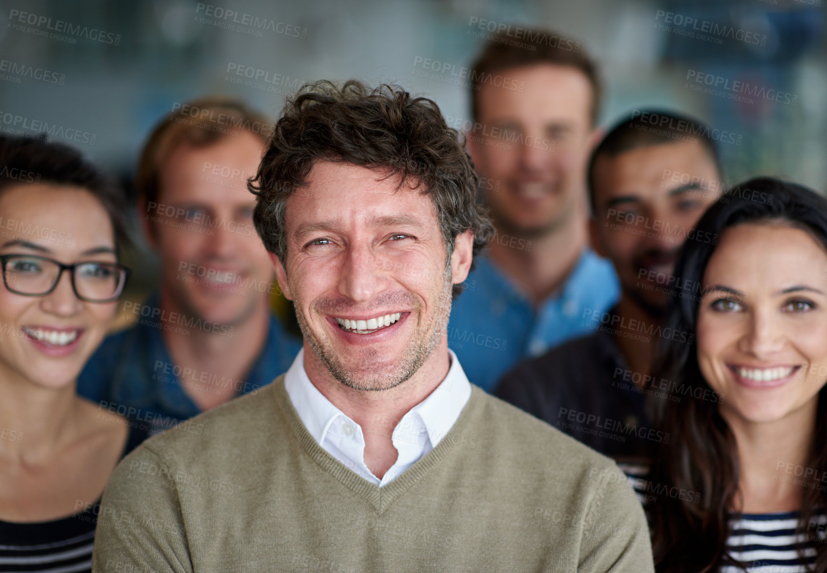 Buy stock photo Shot of a smiling group of coworkers standing in an office