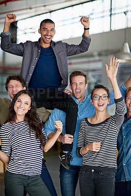 Buy stock photo Businessman sitting on coworker's shoulders while everyone celebrates in the office