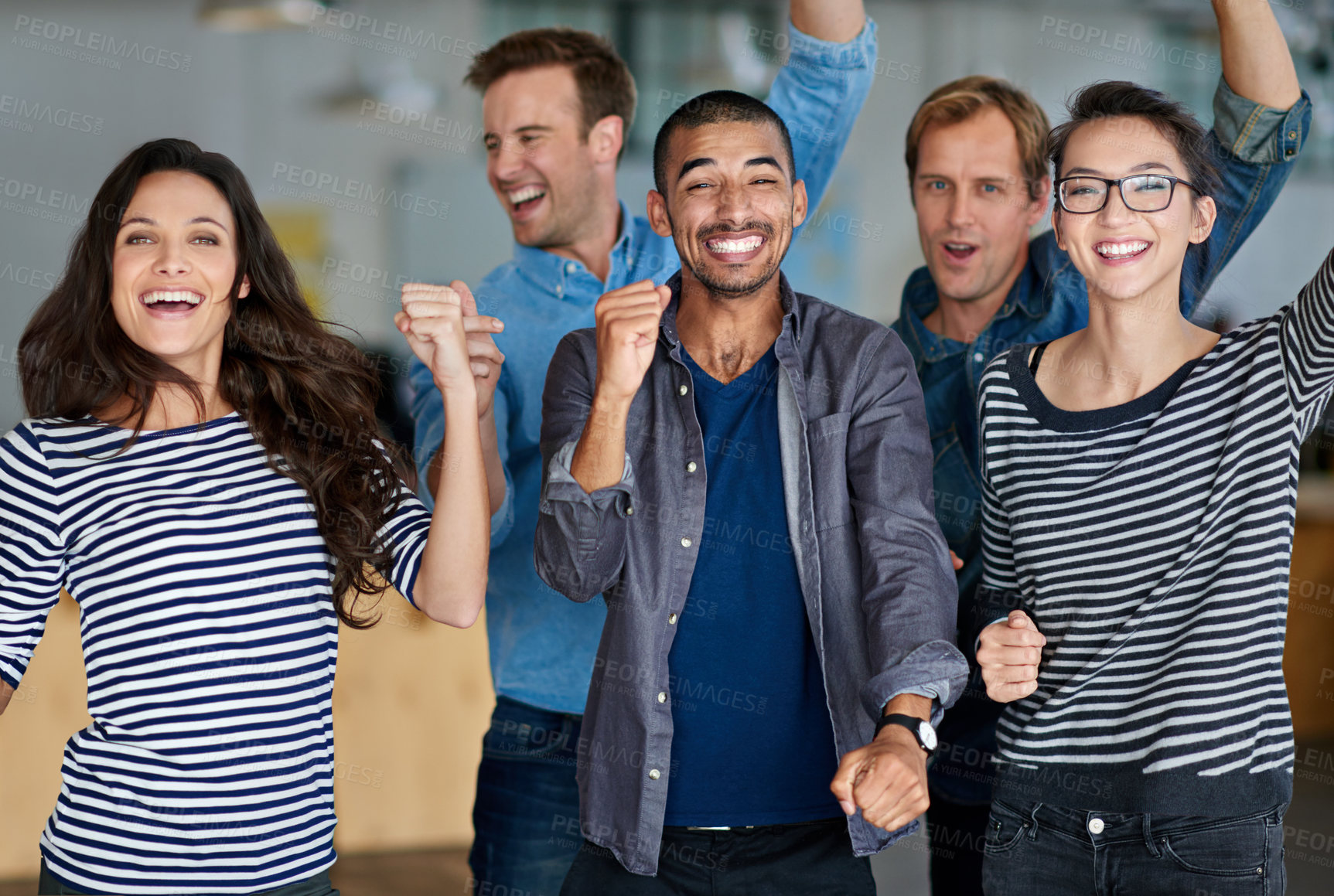 Buy stock photo Diverse group of positive staff members celebrating together in their office