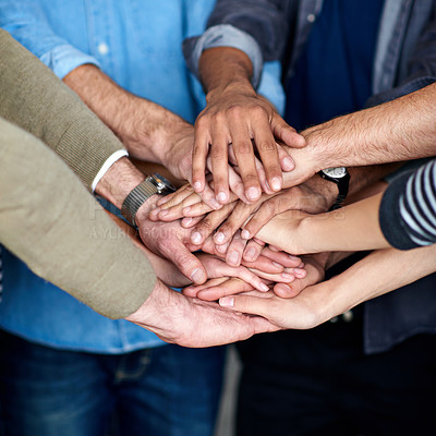 Buy stock photo Cropped view of a multi ethnic group putting their hands together in unity
