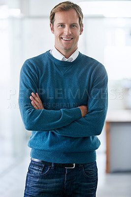 Buy stock photo Portrait of a handsome young businessman standing in an office