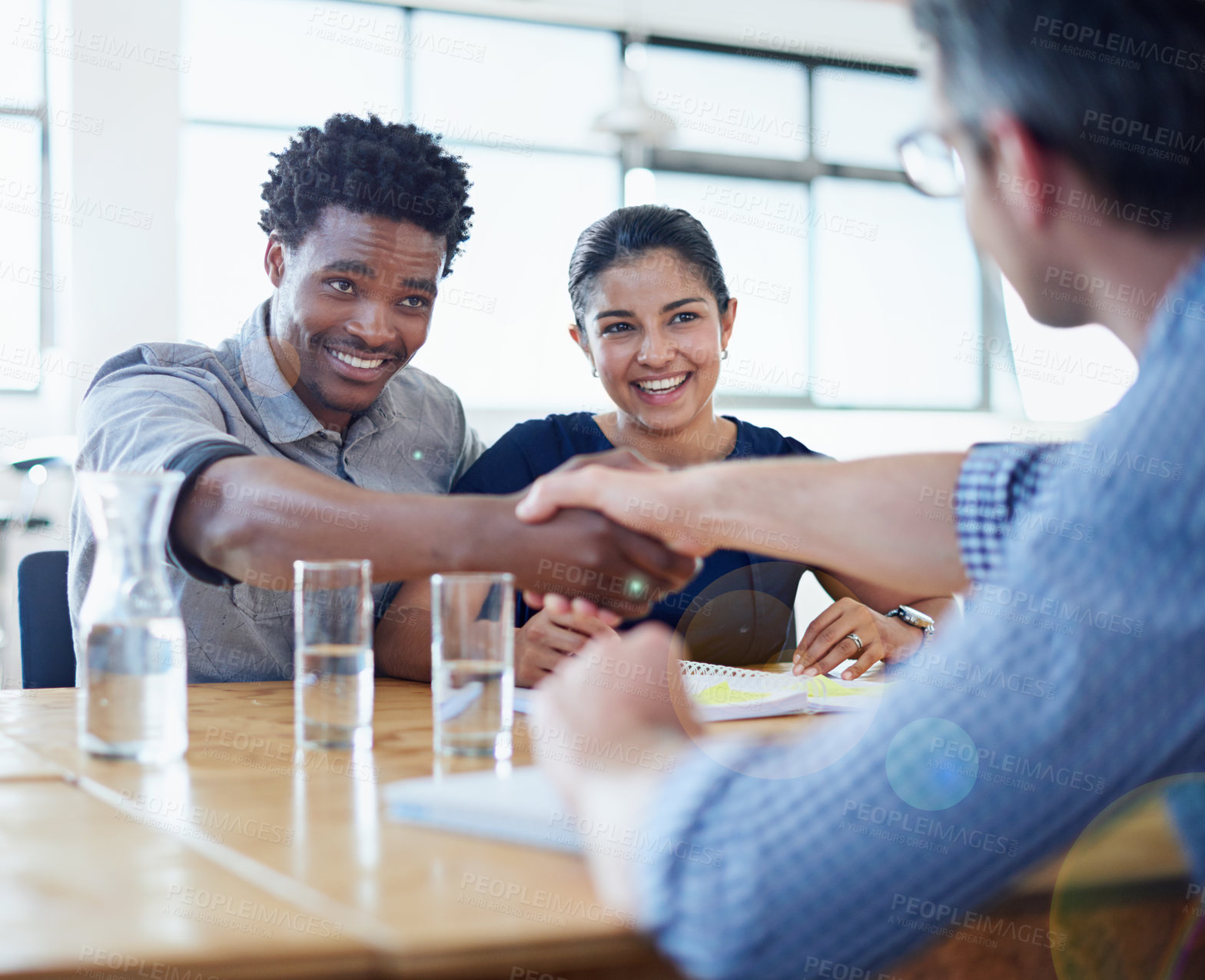 Buy stock photo Shot of two businessmen shaking hands in a meeting