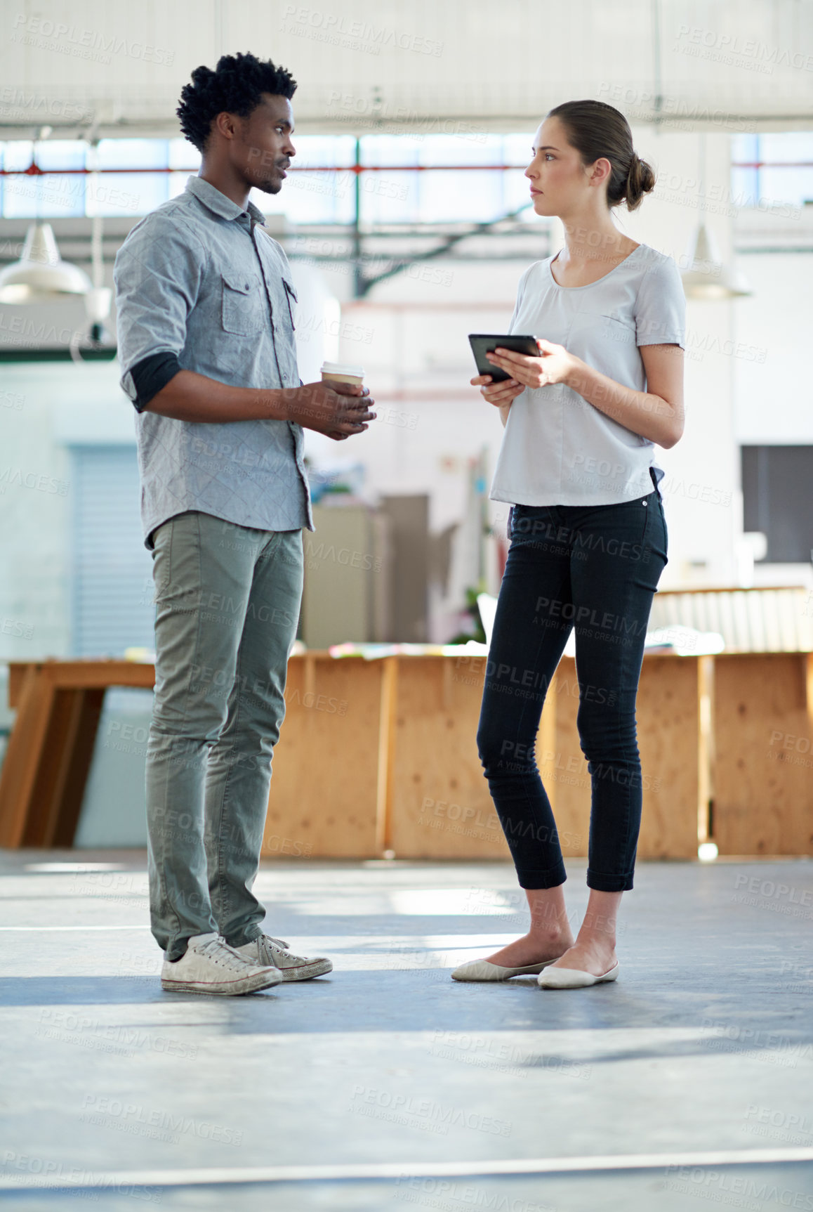 Buy stock photo Shot of two coworkers having a work discussion in the office