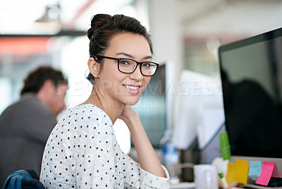 Buy stock photo Portrait, smile and creative business woman in office at startup company on computer in Greece. Face, professional entrepreneur and happy employee, worker or web developer in glasses at workplace