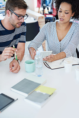 Buy stock photo Shot of coworkers talking over a digital tablet