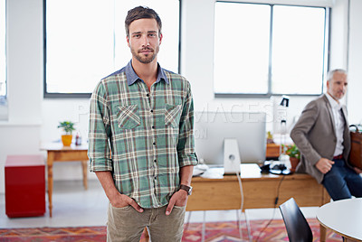 Buy stock photo Portrait of a stylish young man standing in an office with a colleague in the background