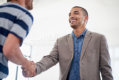 Buy stock photo Low angle shot of two colleagues shaking hands