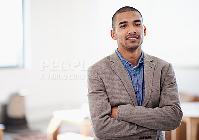 Buy stock photo Shot of a young man standing in an office