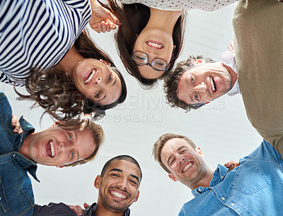 Buy stock photo Low angle shot of a team of people smiling down at the camera positively