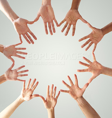 Buy stock photo Low angle shot of hands in a circle forming a circle