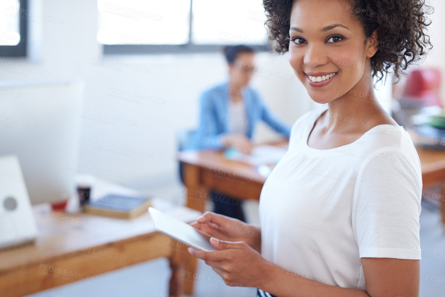 Buy stock photo Beautiful businesswoman smiling at the camera with open office space behind her