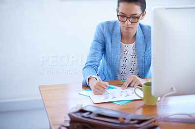 Buy stock photo Cropped shot of a young businesswoman working at her desk, with copyspace