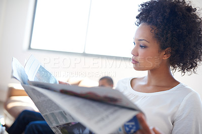 Buy stock photo Woman, reading and newspaper on sofa for trending story, information or knowledge on stock market in living room. Publication, update and person for global events, newsletter or article in home