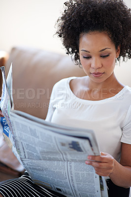 Buy stock photo Reading, woman and newspaper on couch for information, article or knowledge on stock market in living room. Publication, update and person for global events, newsletter or trending story in home