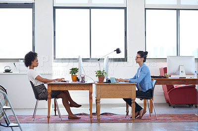 Buy stock photo Wide angle image of two female creative professionals in an open plan office space