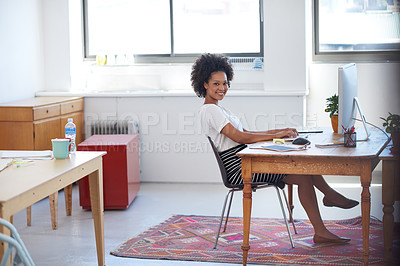 Buy stock photo Beautiful creative professional sitting at her desk in an open plan office space