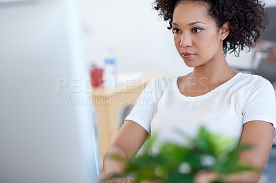 Buy stock photo Tilted view of a beautiful businesswoman working on her pc at the desk