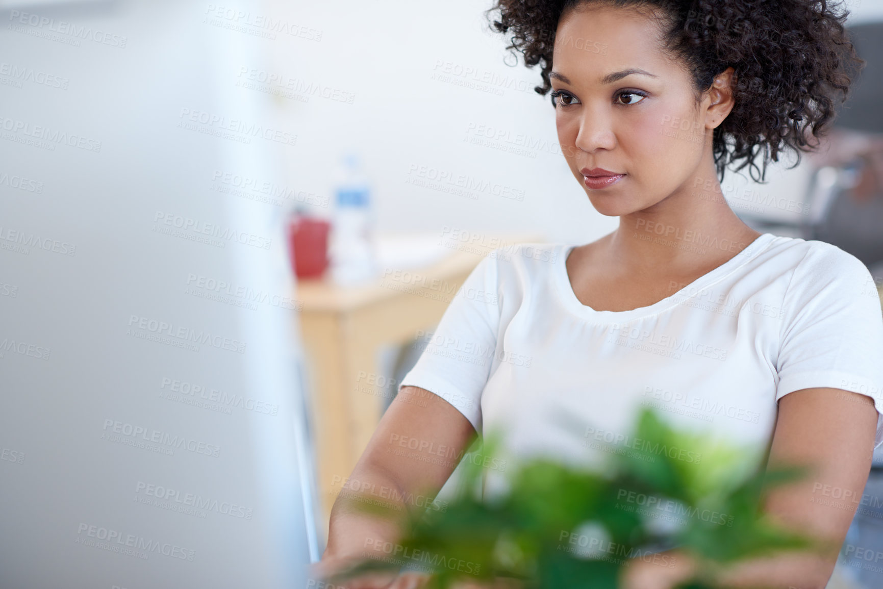 Buy stock photo Tilted view of a beautiful businesswoman working on her pc at the desk