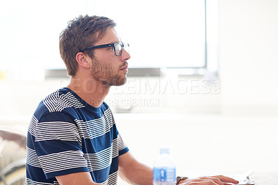 Buy stock photo Cropped shot of a young man working in a bright work space