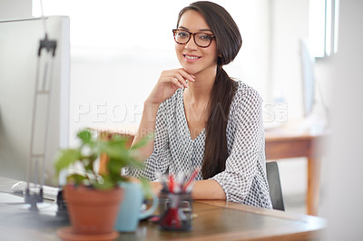 Buy stock photo Beautiful young creative professional sitting at her desk smiling at the camera