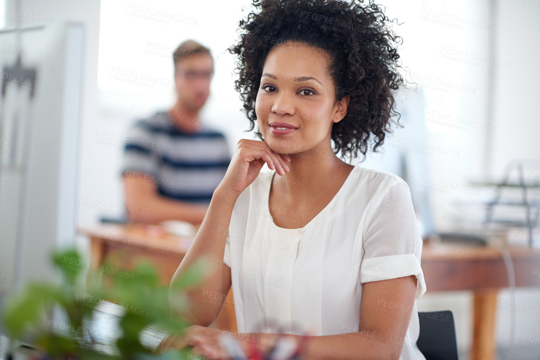 Buy stock photo Portrait of a smiling young designer working on a computer at a desk in an office