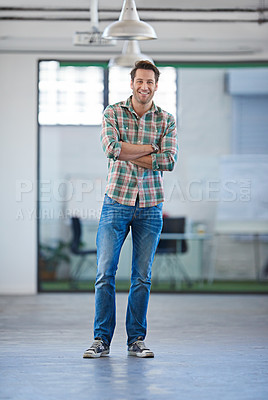 Buy stock photo Handsome man standing in anopen industrial space in informal clothing looking positive