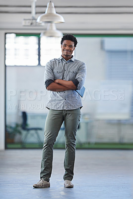 Buy stock photo Confident African man standing smiling with his arms crossed in a modern office space