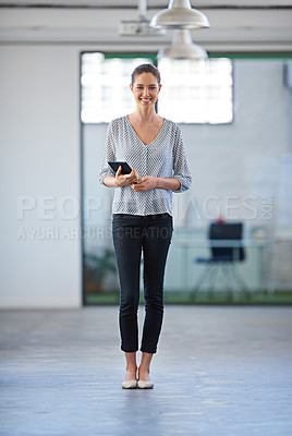 Buy stock photo Beautiful young woman standing smiling at the camera in a modern office space