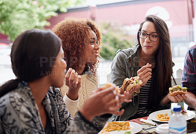 Buy stock photo Cropped shot of a friends eating burgers outdoors