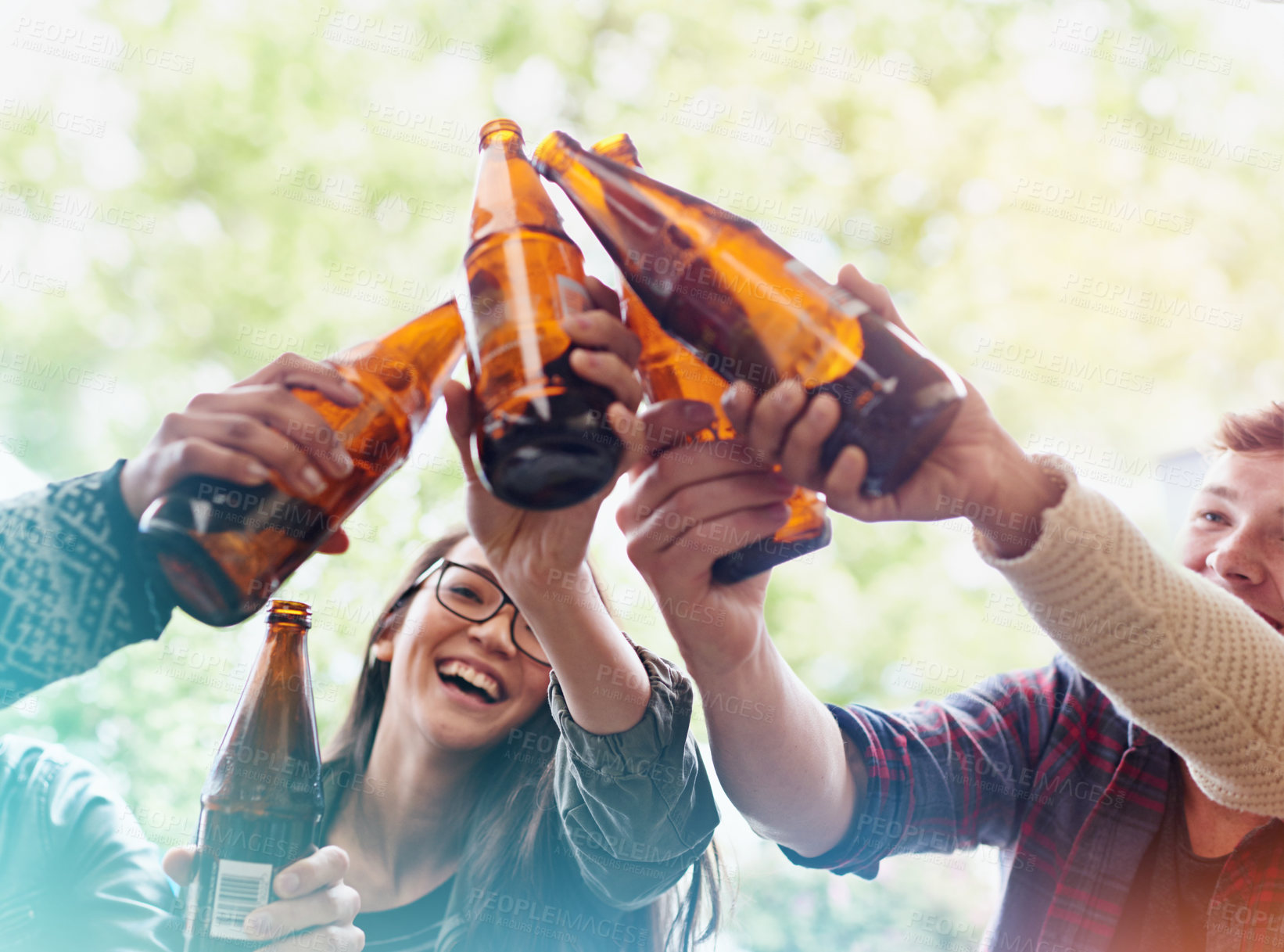 Buy stock photo Friends, beer and toast for celebration outdoor, bonding and fun with people drinking at party, social event or gathering. Happy, cheers for success or achievement, support and trust with alcohol