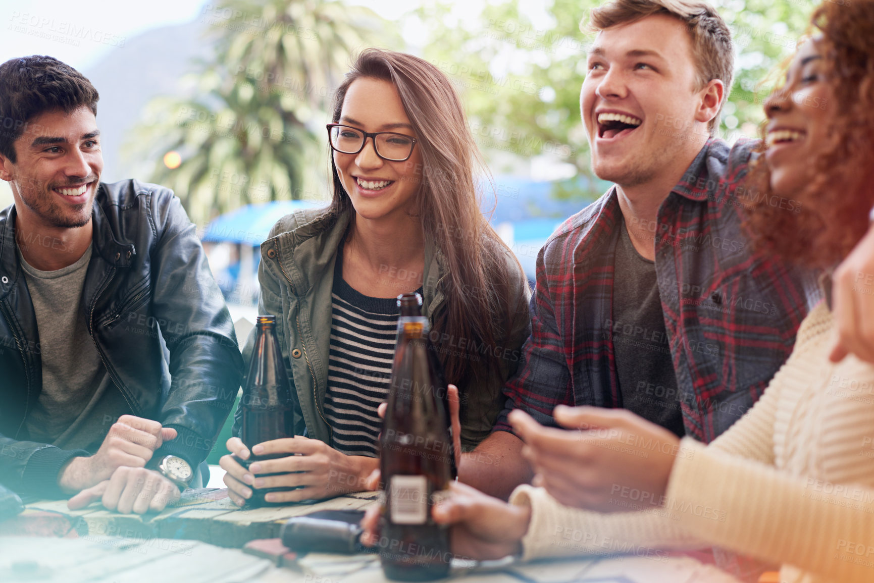 Buy stock photo Friends with beer, drinking and laughing together in pub, restaurant outdoors and reunion on weekend. People, men and women with social gathering, celebration and alcohol with happiness or joy 