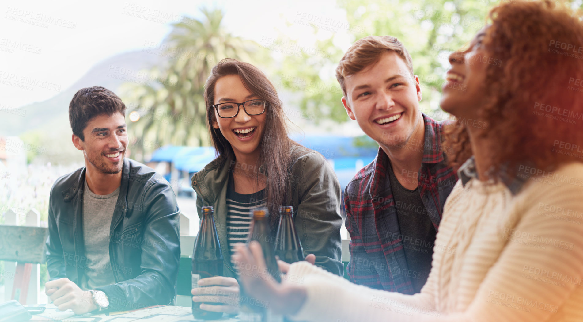 Buy stock photo Friends with alcohol, drinks and laughing in pub, restaurant outdoors and reunion on weekend. People, men and women  with social gathering together, celebration and beers with happiness or joy 