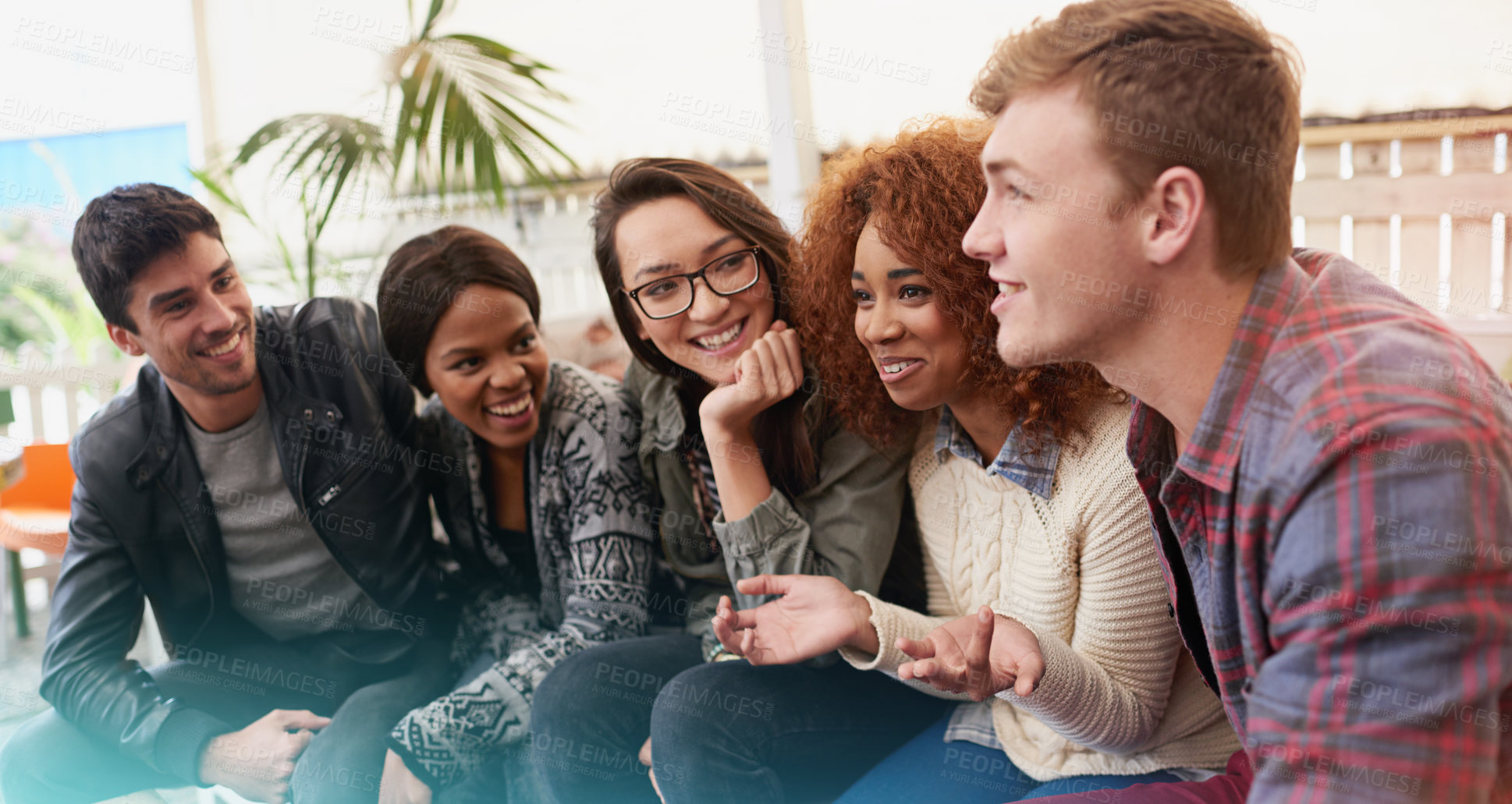 Buy stock photo Cropped shot of a group of friends laughing and having a good time