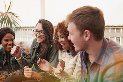 Buy stock photo Cropped shot of a group of friends laughing and having a good time