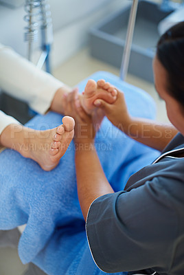 Buy stock photo Cropped shot of a woman having her feet massaged at a beauty spa