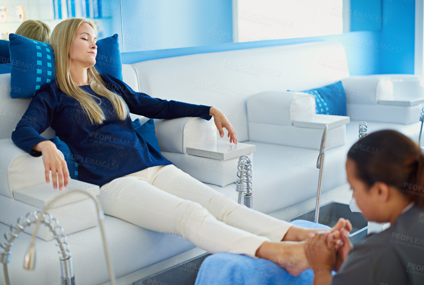 Buy stock photo Shot of a woman having her feet massaged at a beauty spa