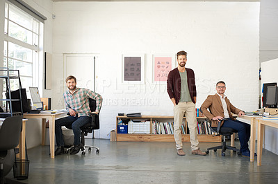 Buy stock photo Open office space with 3 male creative professionals looking at the camera