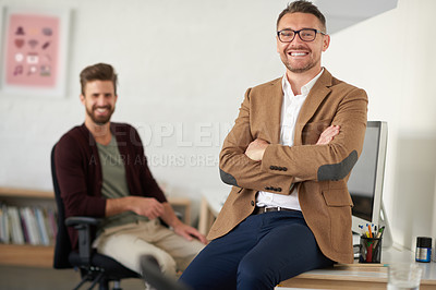 Buy stock photo Smiling mature professional with a younger colleague in the background