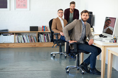 Buy stock photo Three creative professional men at the their desks in a creative office space