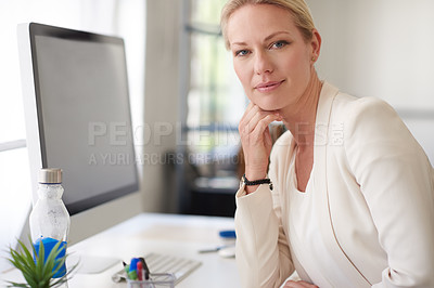 Buy stock photo Portrait of a beautiful businesswoman looking confidently at the camera while sitting at her desk