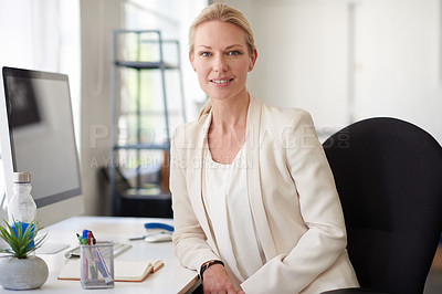 Buy stock photo Confident businesswoman looking positively at the camera in her bright office space
