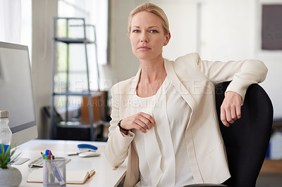 Buy stock photo Confident businesswoman looking at the camera in her bright office space