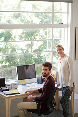 Buy stock photo Male and female colleagues in a relaxed office space smiling at the camera